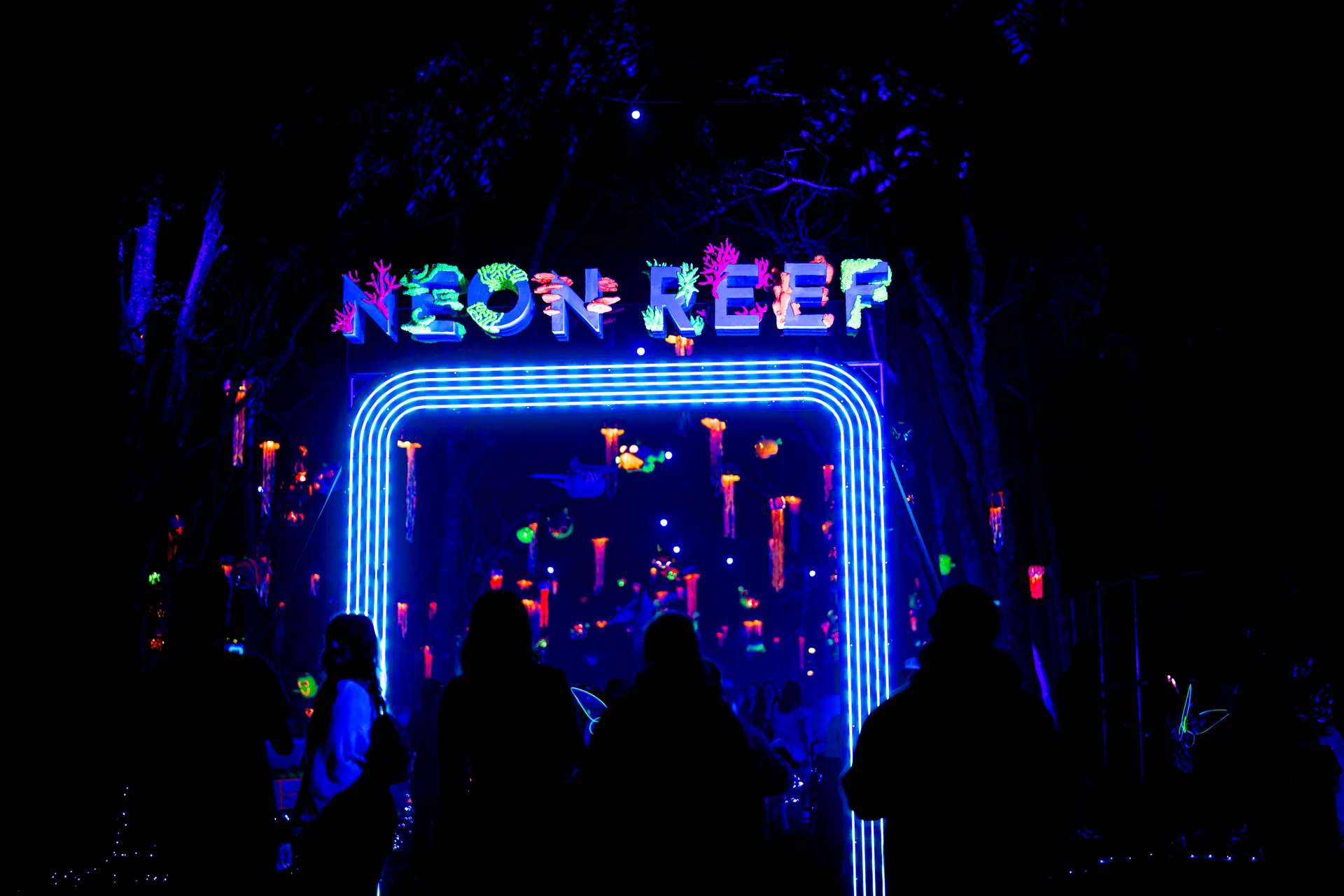 Neon Reef entrance glowing in blue and coral light