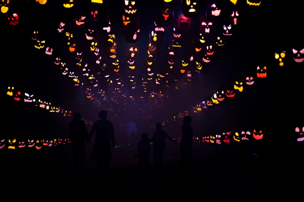 Guests walking the glowing pumpkin tunnel
