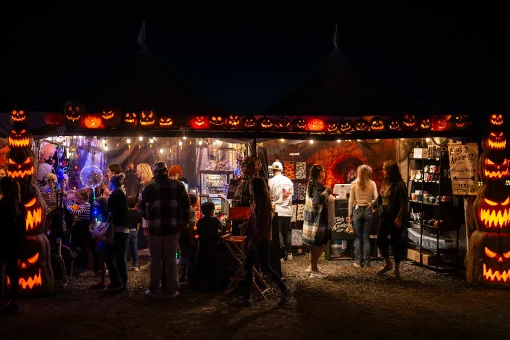 Vendor stall in Pumpkin Village at night